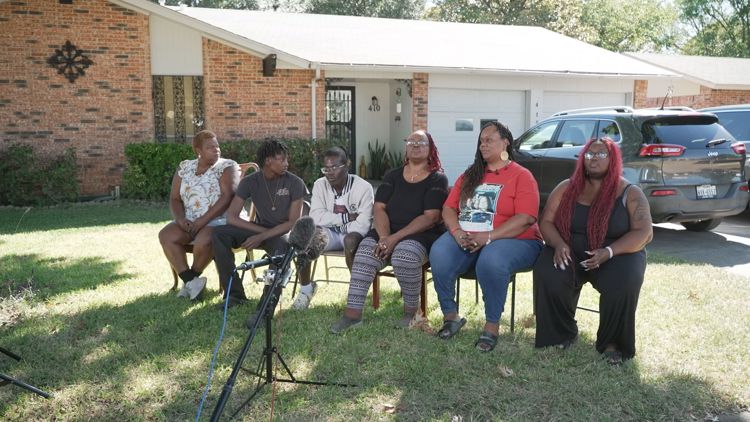 Family members embracing at a memorial for Cecilia Simpson in Dallas, seeking justice.
